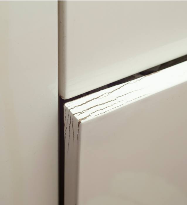 A cabinet with cracked corners.